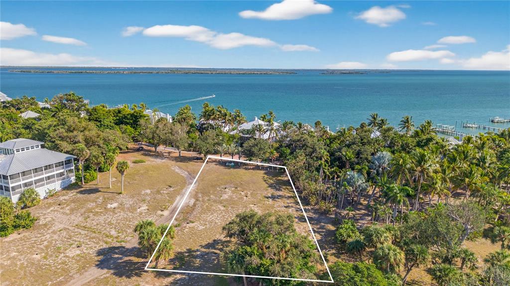 An aerial view shows a vacant, trapezoidal lot near a body of water — 326 USEPPA ISLAND, CAPTIVA, FL