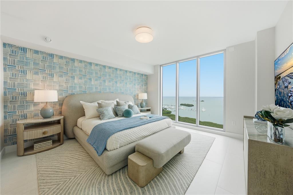 A modern bedroom features a patterned blue accent wall, a king bed, and floor-to-ceiling windows — 5713 BOWEN DANIEL DRIVE UNIT 1505, TAMPA, FL