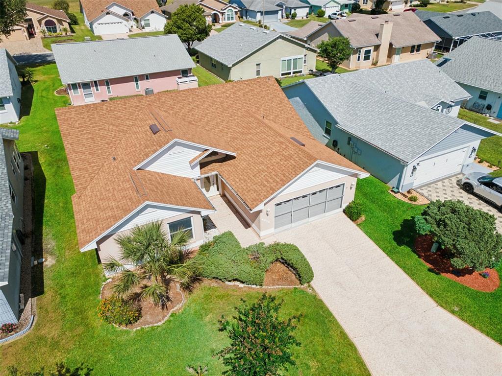An aerial view shows a suburban house with a brown shingled roof and concrete driveway — 6232 EGRET DRIVE, LAKELAND, FL