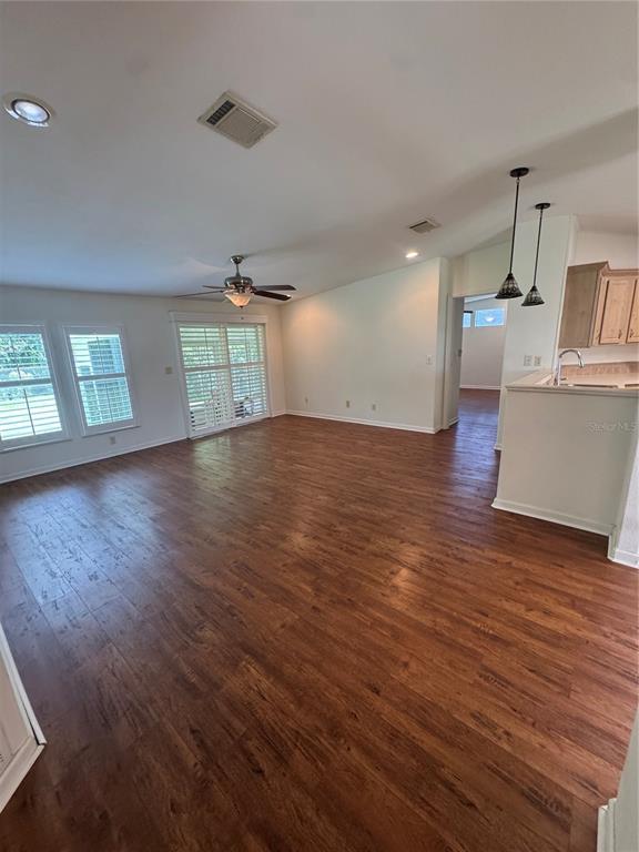 A single-story house with light siding, green shutters, and an attached carport on a grassy lot — 585 OUTER DRIVE, COCOA, FL
