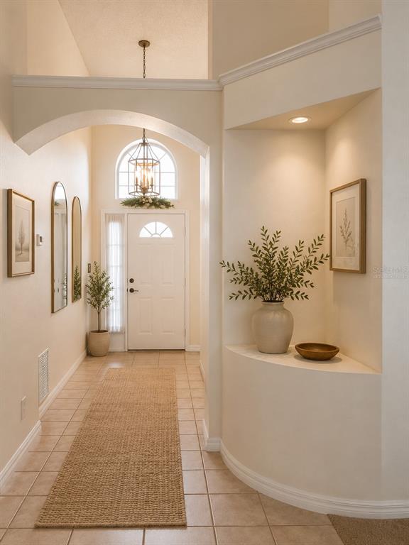 An empty bedroom with beige carpet, a ceiling fan, and a window with white curtains — 7935 OAKSTONE COURT, ORLANDO, FL