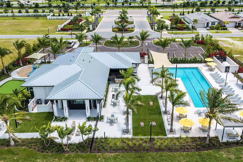 An aerial view of a community amenity center featuring a swimming pool and tennis courts — 12209 NEW TRANQUILITY PATH, VENICE, FL