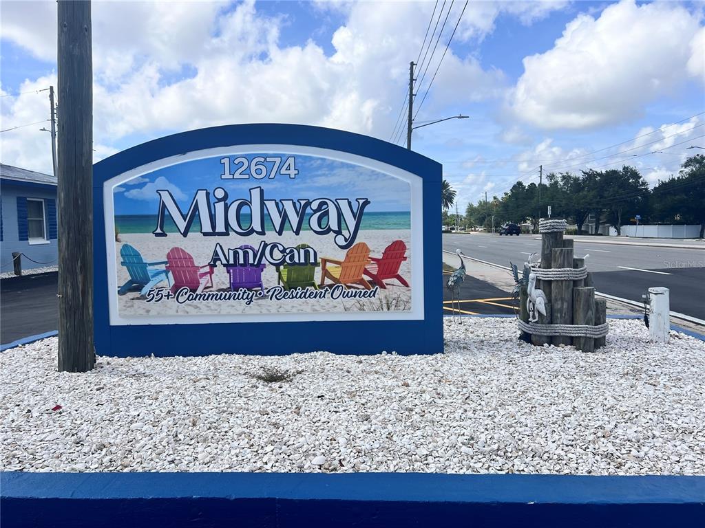 A blue sign for a 55+ community stands in a bed of white gravel — 12674 SEMINOLE BOULEVARD UNIT C35, LARGO, FL
