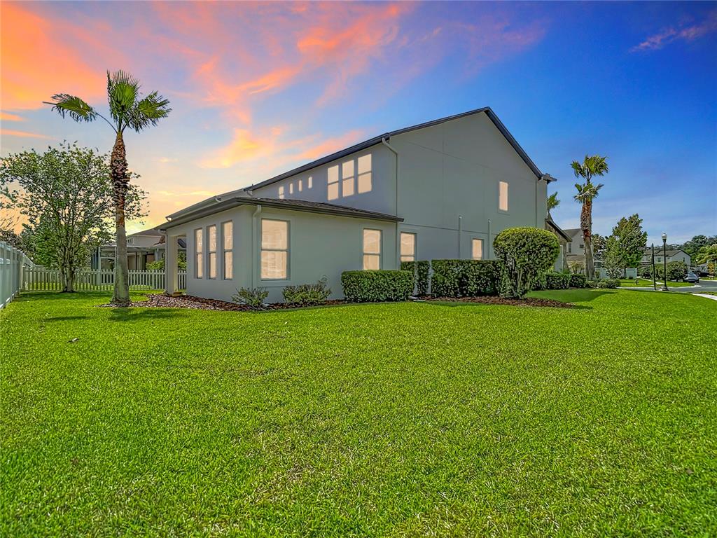 A two-story house with a stone facade, arched entryway, and a two-car garage — 27387 CAYENNE LANE, WESLEY CHAPEL, FL