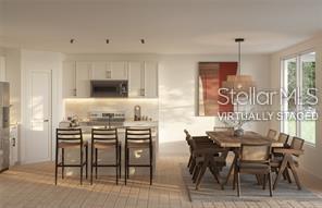 This is a virtual rendering of a kitchen and dining area with light wood flooring — 19 BONNIE LANE, PALM COAST, FL