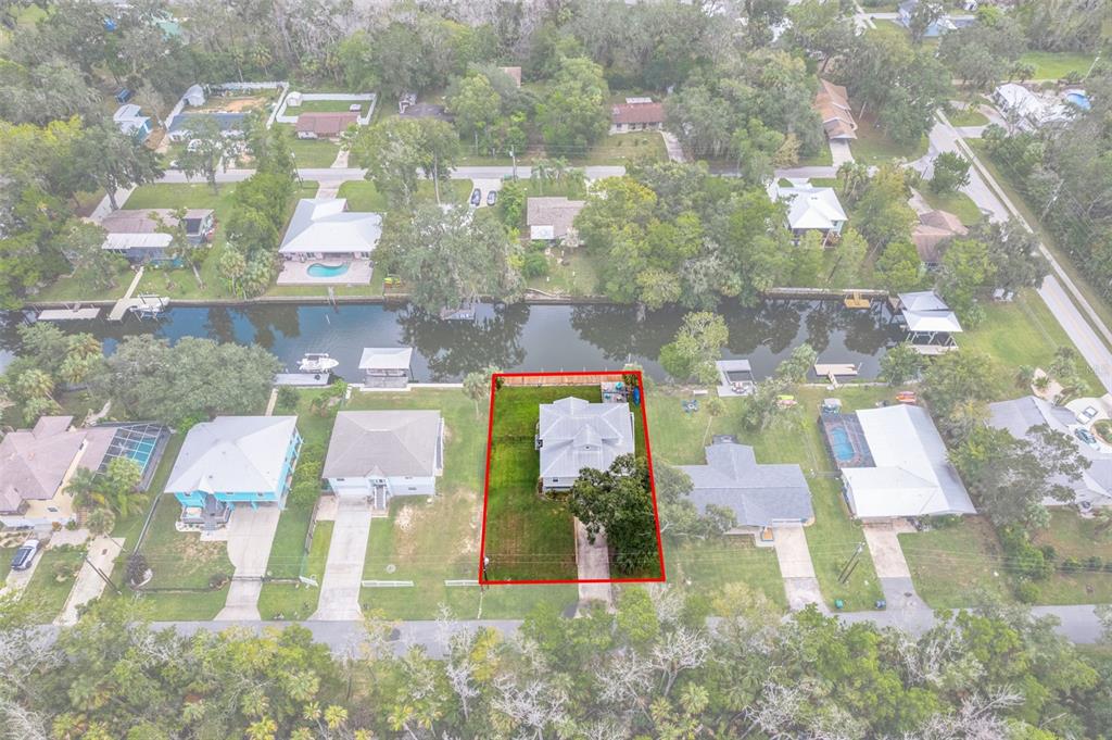 An aerial view shows a house with a red-outlined yard bordering a canal — 3625 N SUWANNEE POINT, CRYSTAL RIVER, FL