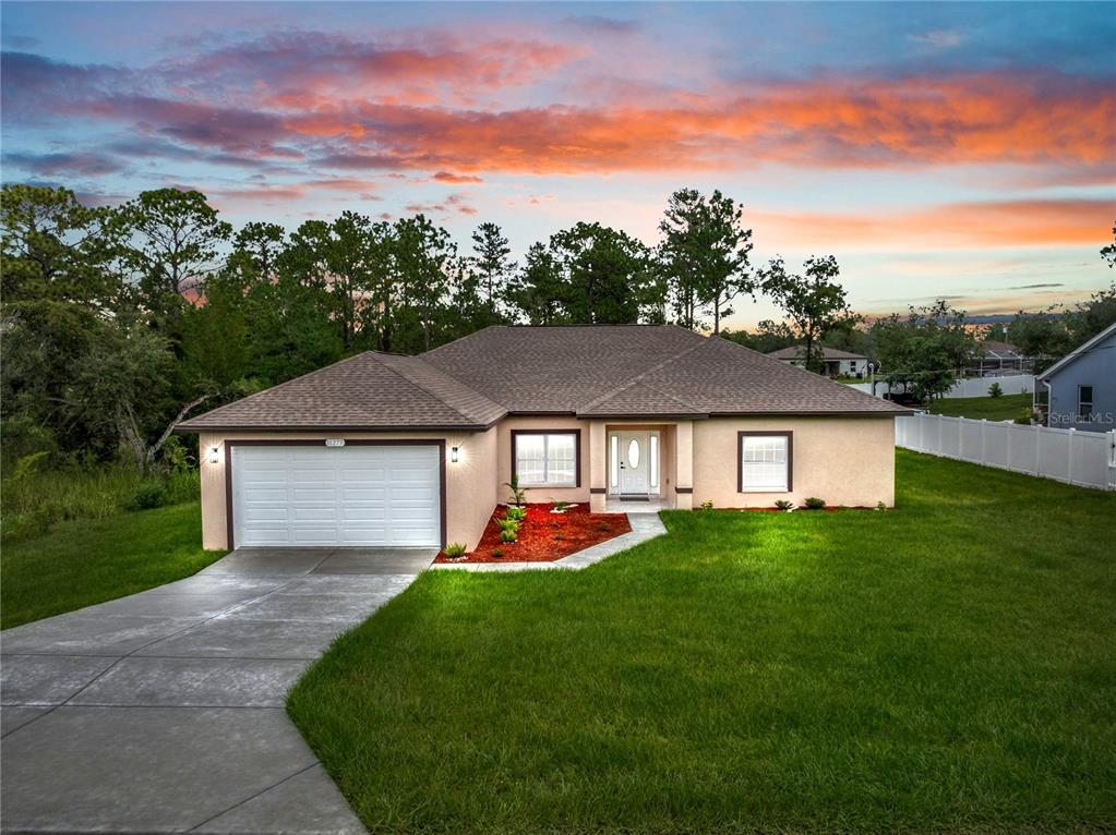 An aerial view shows a single-story house situated on a large, partially wooded residential lot — 11277 FOOL DUCK AVENUE, WEEKI WACHEE, FL