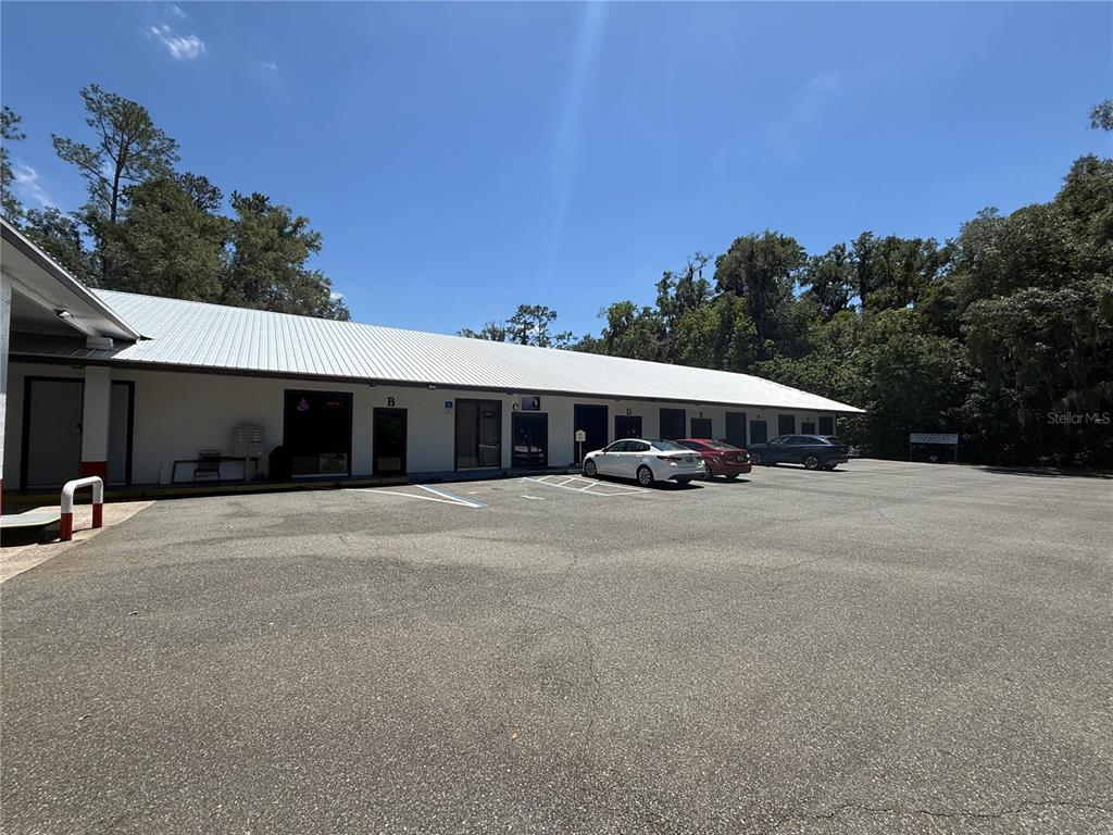A single-story commercial building with multiple unit entrances and a paved parking lot — 3380 SE LAKE WEIR AVENUE UNIT A, OCALA, FL