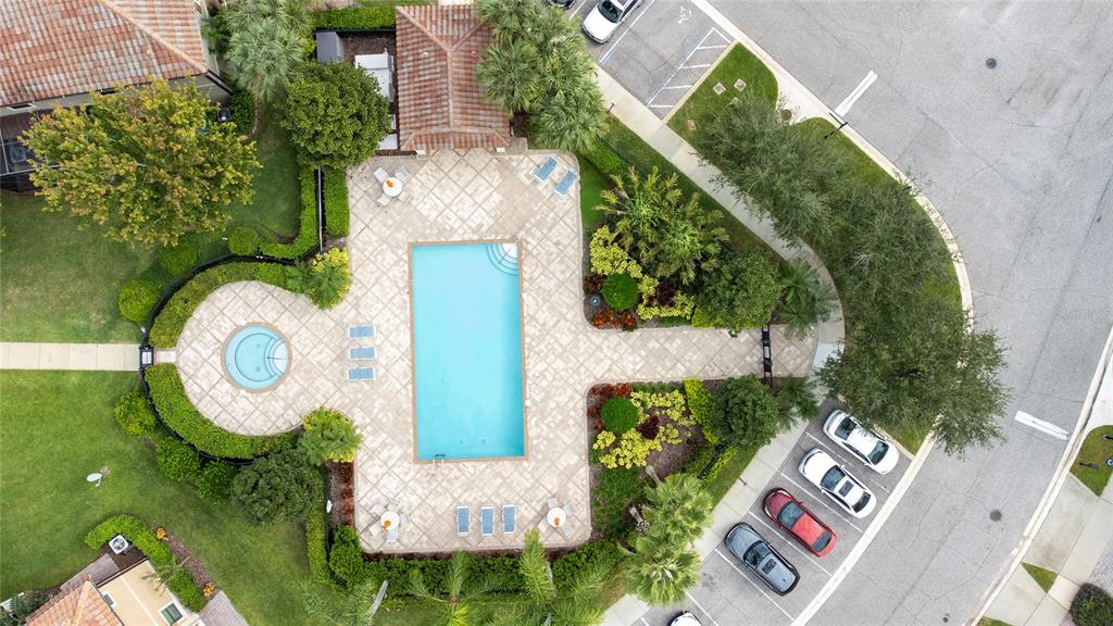 An aerial view shows a rectangular swimming pool, a circular spa, and surrounding patio area — 8349 KELSALL DRIVE, ORLANDO, FL