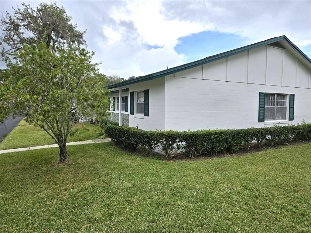 An empty living room features light gray walls, wood-look flooring, and a ceiling fan — 201 N HILL AVENUE UNIT 150, DELAND, FL