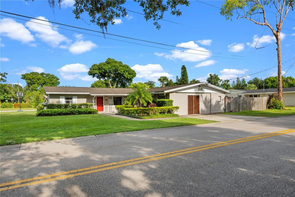 A single-story house with a red front door, a garage, and a grassy front yard — 601 ORANOLE ROAD, MAITLAND, FL