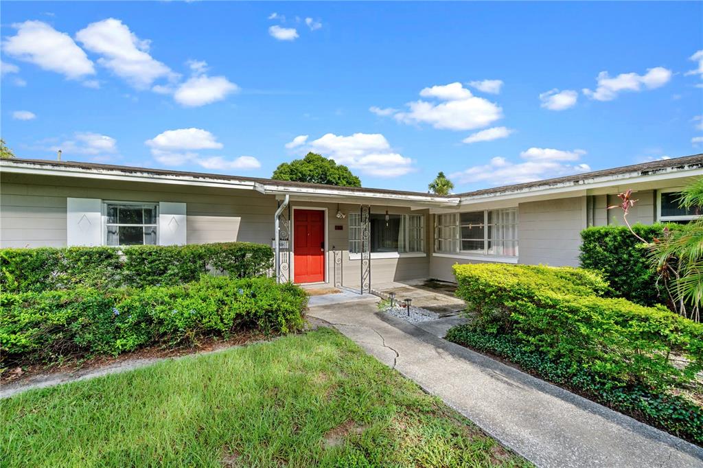 A single-story house with a red front door, gray siding, and a concrete walkway — 601 ORANOLE ROAD, MAITLAND, FL