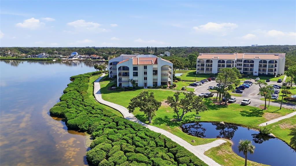 A kitchen features white cabinets, granite countertops, stainless steel appliances, and a breakfast bar — 301 MARINER DRIVE UNIT 301, TARPON SPRINGS, FL