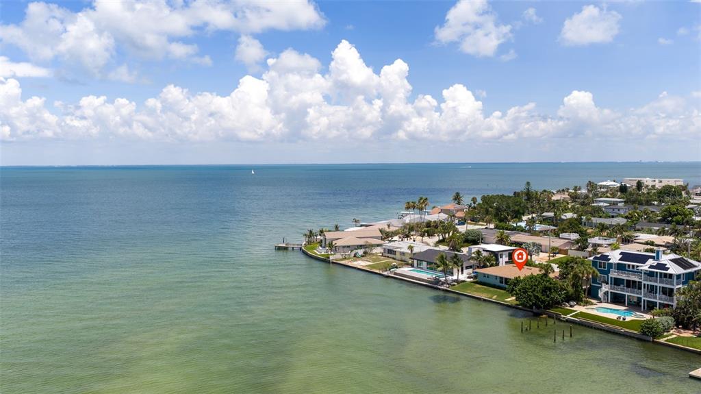 An aerial view shows a waterfront house with a red location pin on the roof — 501 22ND AVENUE SE, ST PETERSBURG, FL