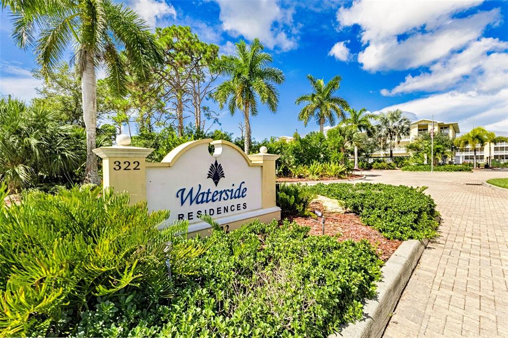 A sign for Waterside Residences stands in front of lush landscaping and palm trees — 101 NATURES WAY UNIT 1307, ROTONDA WEST, FL