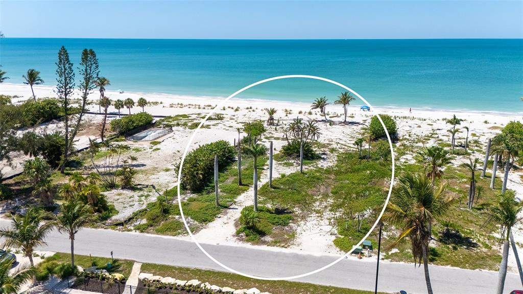 An aerial view shows a vacant coastal lot with palm trees and sandy vegetation — 6441 GULFSIDE ROAD, LONGBOAT KEY, FL