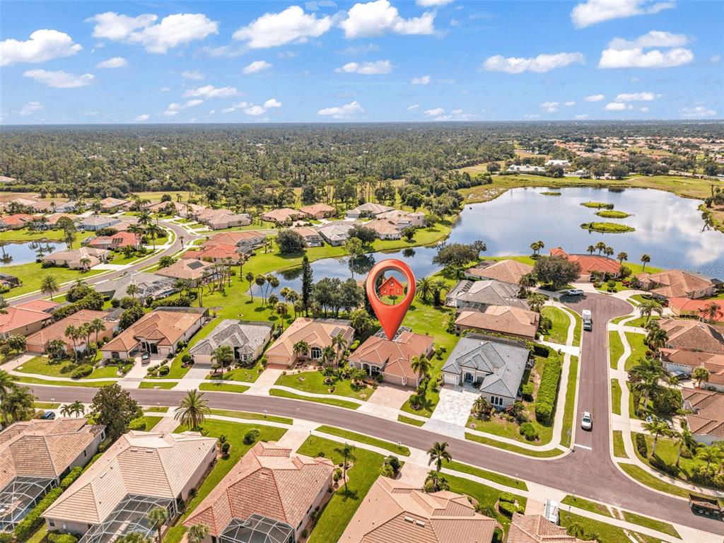 An aerial view shows a residential neighborhood with a red location pin over a house — 2450 SILVER PALM ROAD, NORTH PORT, FL