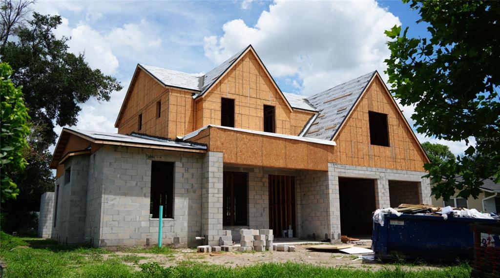 A two-story house under construction with concrete block walls and plywood sheathing on the roof — 648 WORTHINGTON DRIVE, WINTER PARK, FL