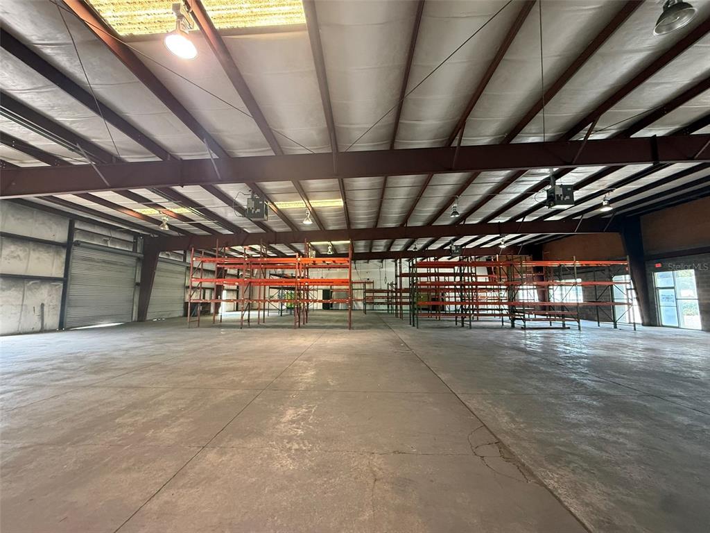 Two electrical breaker panels are mounted on a wall with exposed metal conduit pipes above — 5042 W HIGHWAY 40 UNIT 101, OCALA, FL