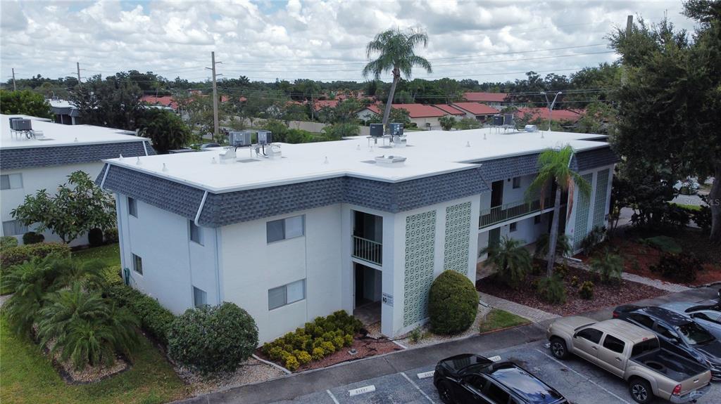 An aerial view shows a two-story apartment building with a flat roof and parking lot — 3606 BENEVA ROAD UNIT 504, SARASOTA, FL