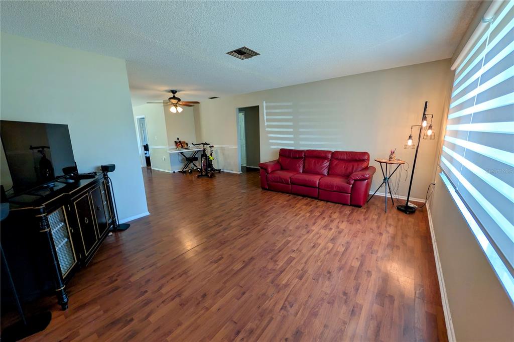 A single-story house with a white brick facade, a two-car garage, and a palm tree — 11608 FOX RUN, PORT RICHEY, FL