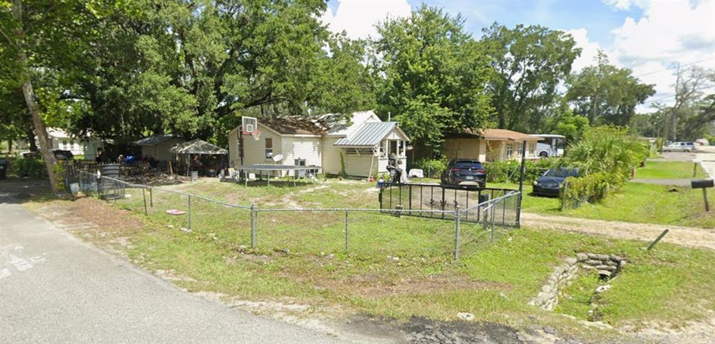 A single-story house with a fenced yard, a trampoline, and a basketball hoop — 434 RING ROAD, ORLANDO, FL