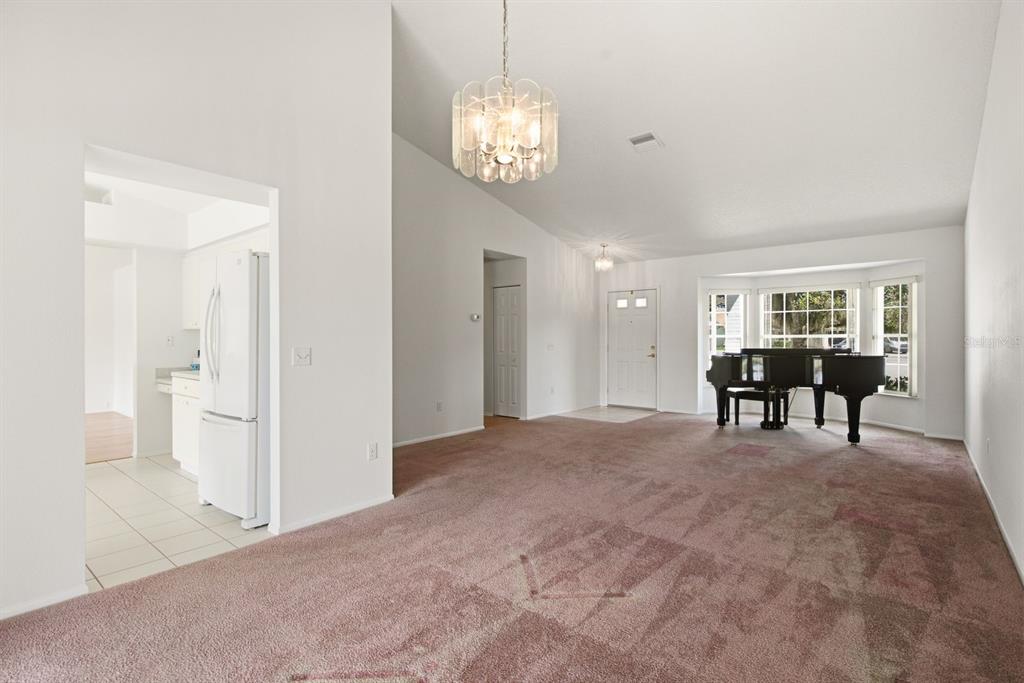 A view of a backyard with a pond, a palm tree, and a tiled patio — 6639 SUN POINT COURT, NEW PORT RICHEY, FL