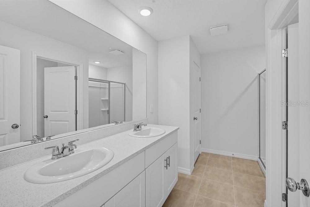 A kitchen features white cabinets, stainless steel appliances, granite countertops, and a large island — 12422 WHISK COURT, HUDSON, FL