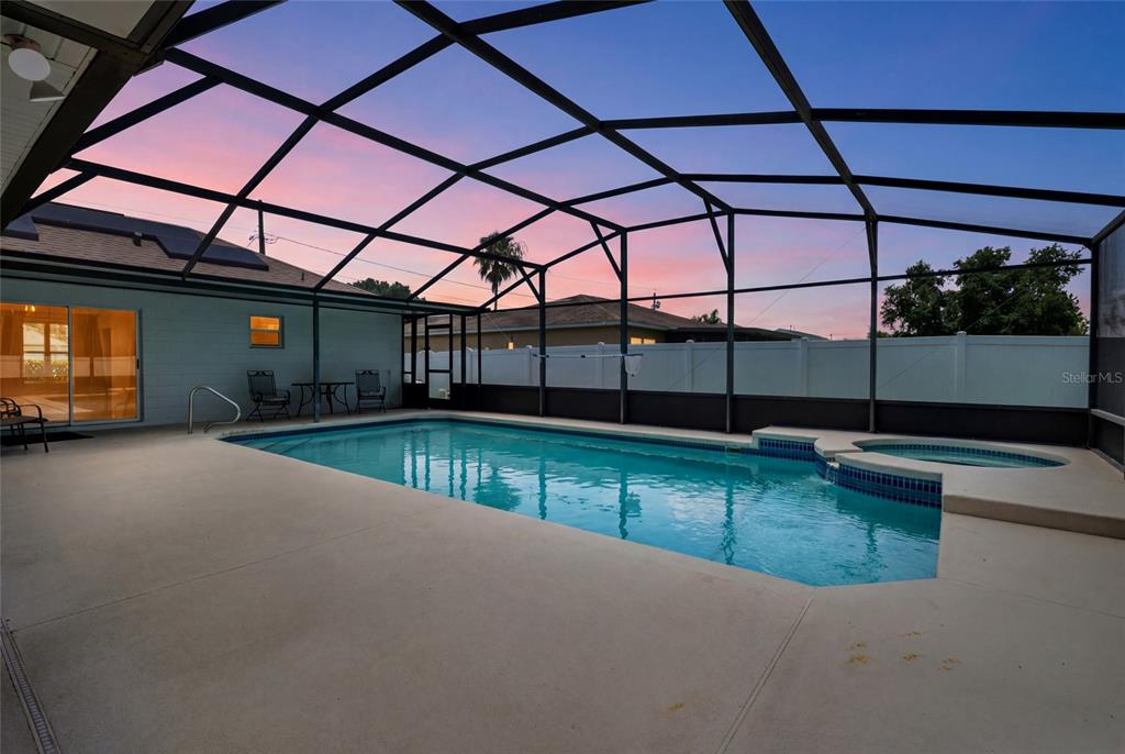 A single-story house with a white exterior, solar panels, and a front-facing garage — 718 TOULON DRIVE, KISSIMMEE, FL
