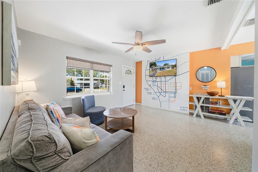 A light blue house with an orange-painted garage door and a paved driveway — 10437 52ND AVENUE N, ST PETERSBURG, FL