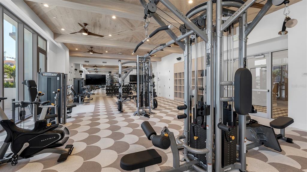 A modern gym features Matrix exercise equipment, a patterned floor, and a wood-paneled ceiling — 225 1ST AVENUE N UNIT A2, ST PETERSBURG, FL