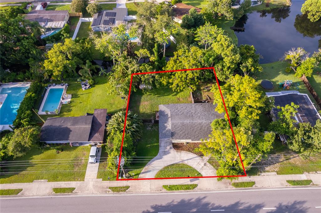 An aerial view shows a single-story house with a driveway and yard outlined in red — 324 SEMINOLA BOULEVARD, CASSELBERRY, FL
