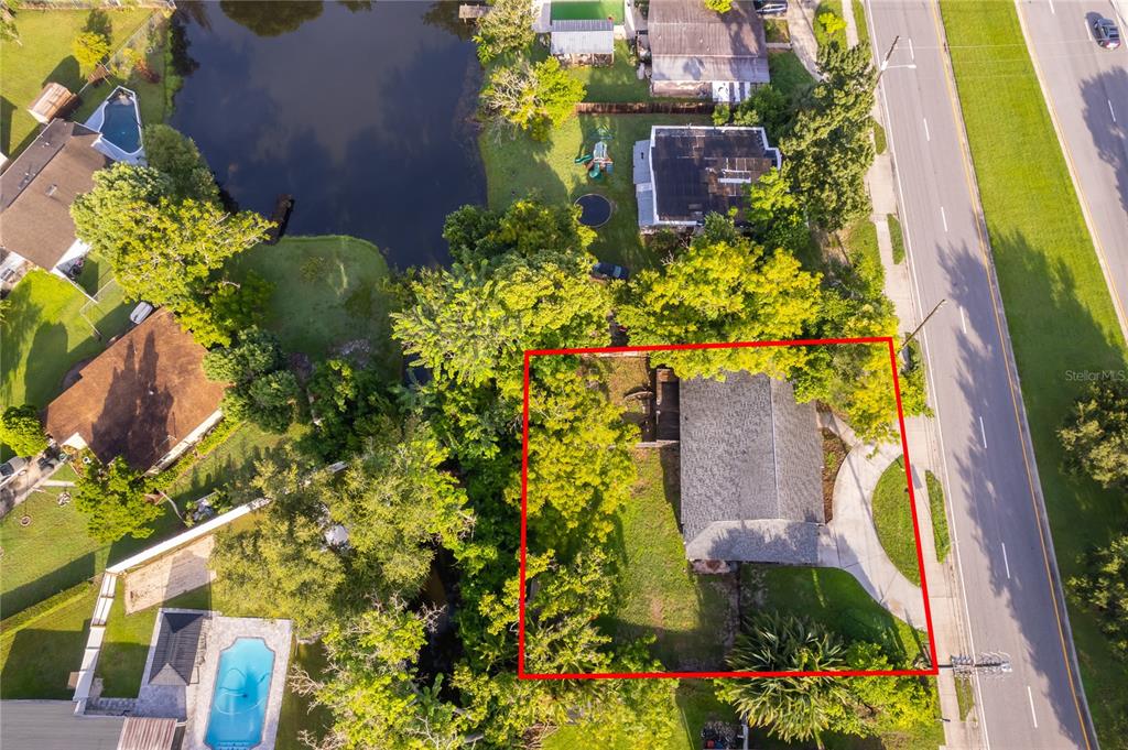 An aerial view shows a residential property with a house outlined in red near a road — 324 SEMINOLA BOULEVARD, CASSELBERRY, FL