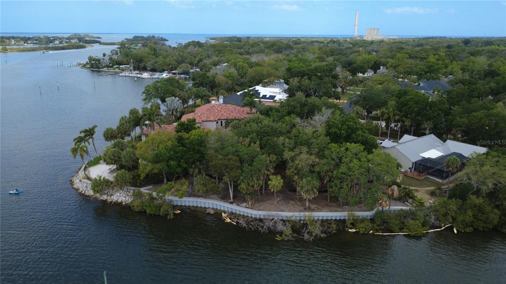 An aerial view shows a long wooden dock with several boats extending into a waterway — 1600 MEYERS COVE DRIVE, TARPON SPRINGS, FL