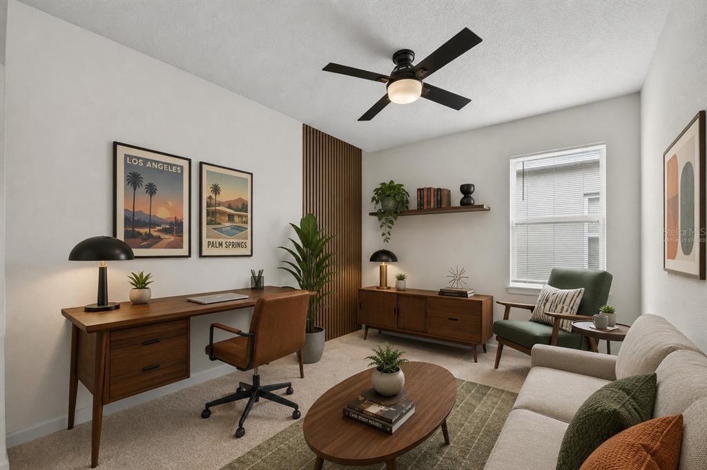 An open-concept living room and kitchen featuring light wood floors, neutral furniture, and cabinetry — 341 WINTER BLISS LANE, MOUNT DORA, FL