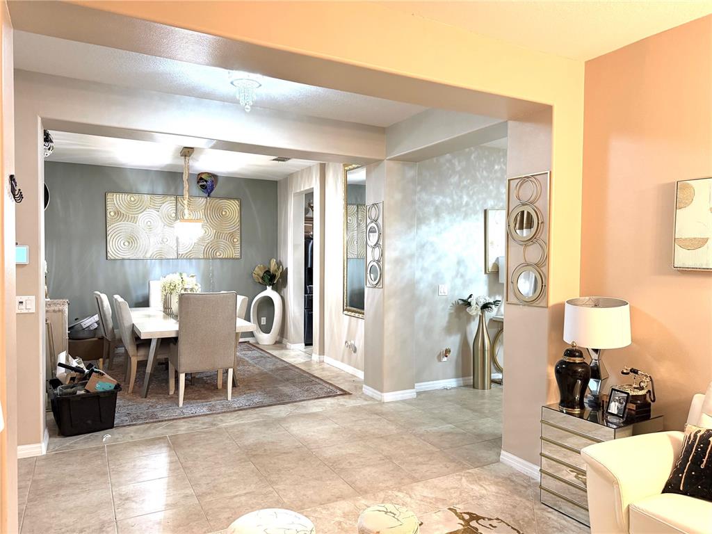A dining room with a table and chairs is visible through an open archway — 3982 BLOSSOM DEW DRIVE, KISSIMMEE, FL