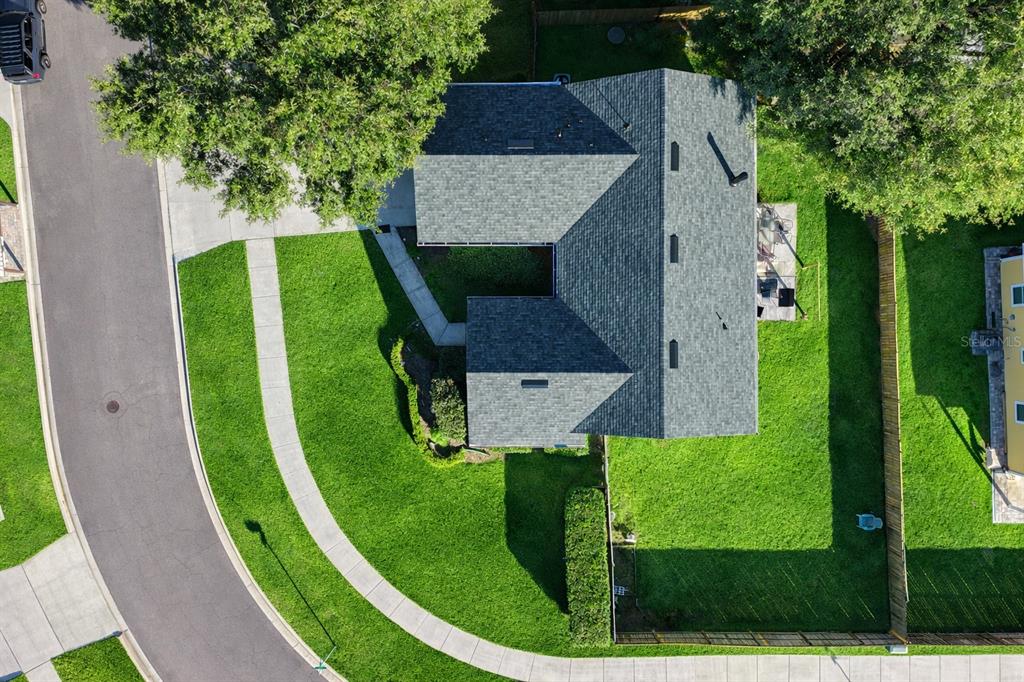 An aerial view shows a house with a gray shingled roof, lawn, and paved driveway — 14271 NW 10TH ROAD, NEWBERRY, FL
