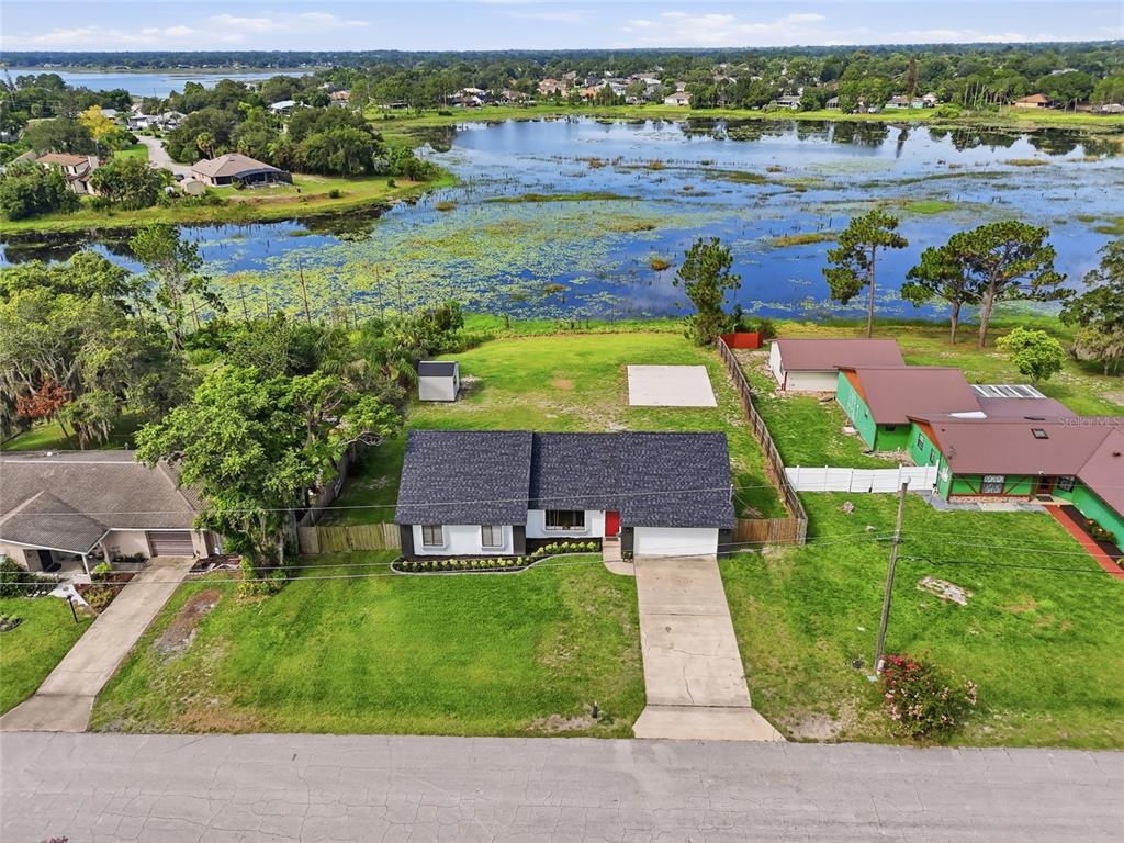An aerial view shows a residential property lot outlined in yellow with a house and shed — 2643 SALTERS COURT, DELTONA, FL
