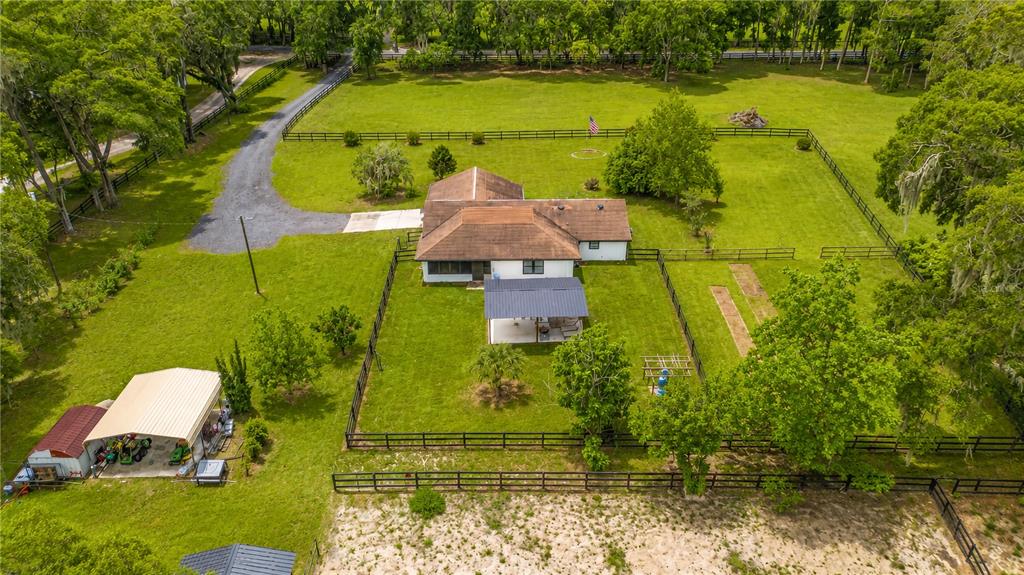 A single-story house with stone accents and a white exterior sits on a grassy lot — 2735 NE 127TH PLACE, ANTHONY, FL