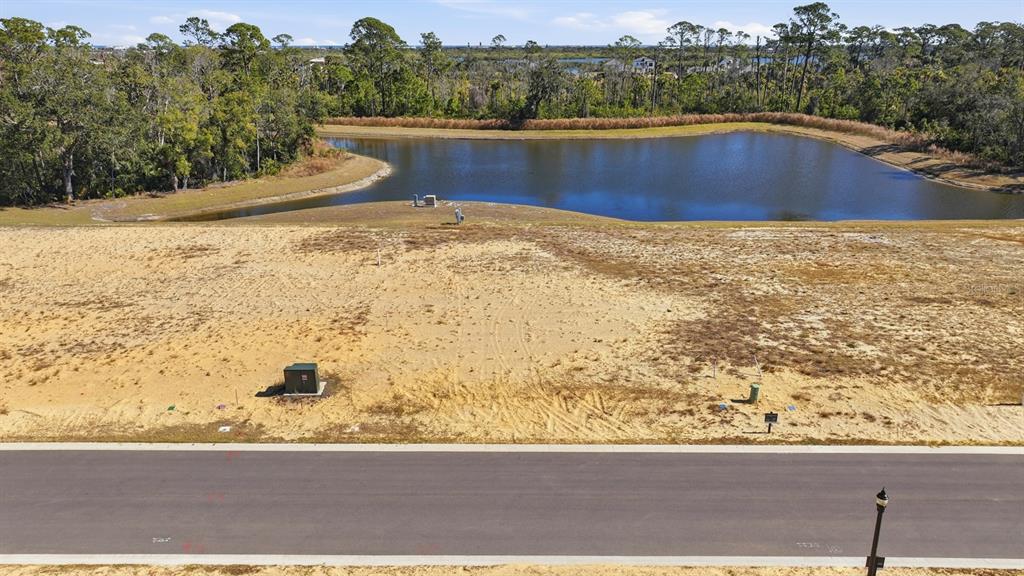 An aerial view of a vacant residential lot overlooking a pond and wooded area — 200 STILLWATER DRIVE, FLAGLER BEACH, FL