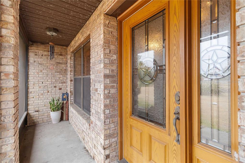 A brick house and a detached garage sit on a large, grassy lot — 18711 NORTHCLIFF STREET, ORLANDO, FL