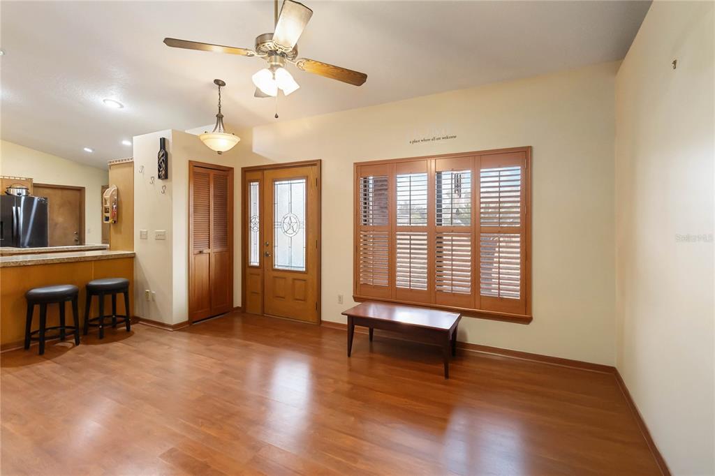 A brick garage with a roll-up door, a side entrance, and an attached metal carport — 18711 NORTHCLIFF STREET, ORLANDO, FL
