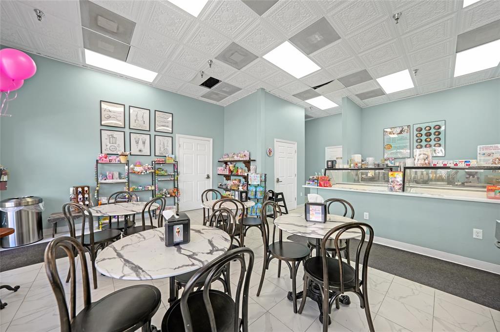 An ice cream shop features marble-topped tables, black chairs, and a service counter — 203 W OAK STREET, ARCADIA, FL