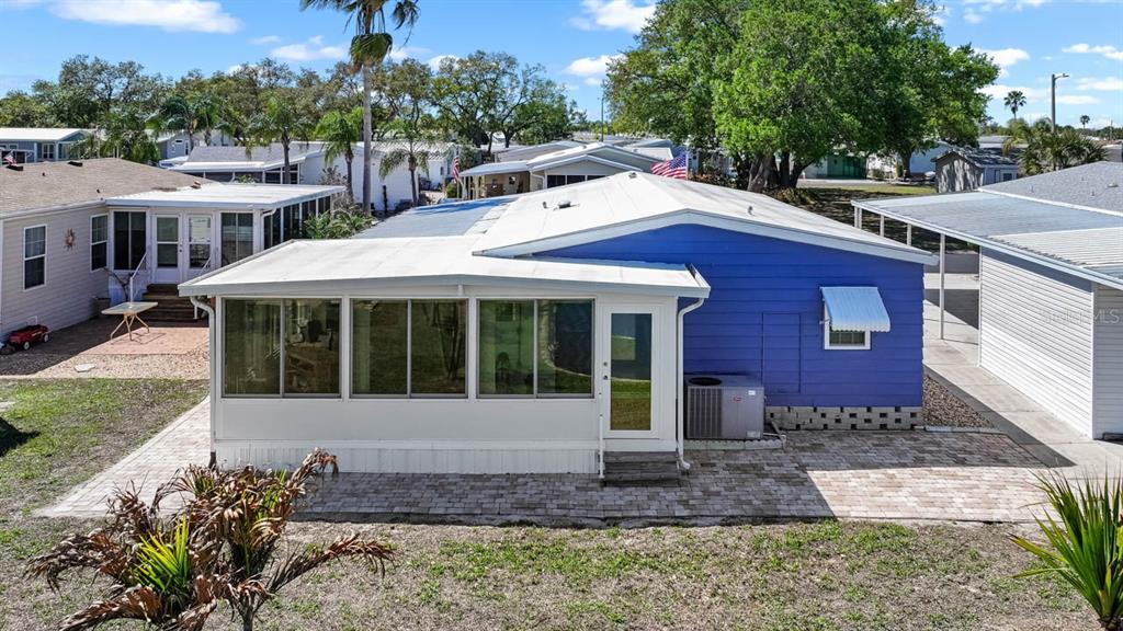 An aerial view shows several mobile homes situated along the edge of a small pond — 101 SAINT GEORGE COURT, APOLLO BEACH, FL