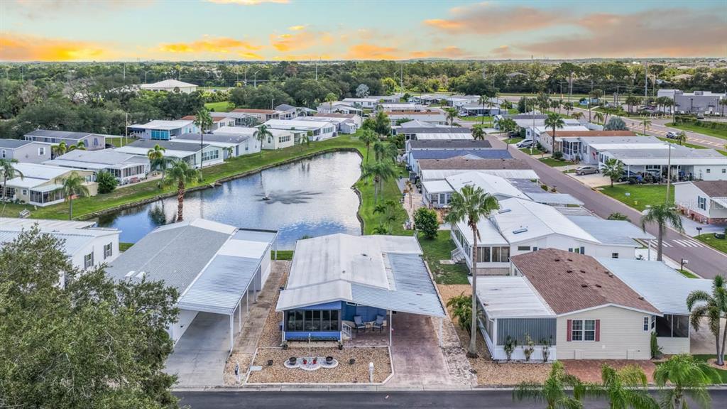 A blue mobile home with a white sunroom and a paved patio area — 101 SAINT GEORGE COURT, APOLLO BEACH, FL