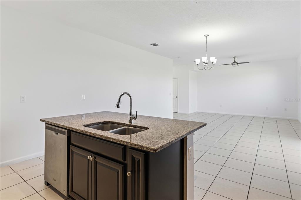 A bright entryway features a white door, a wooden bench, a console table, and baskets — 213 TRINITY RIDGE CIRCLE, DAVENPORT, FL