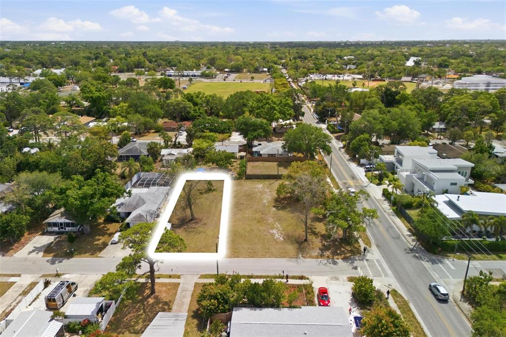 An aerial view shows a vacant rectangular lot highlighted in white next to a road — 0 BAY STREET, SARASOTA, FL