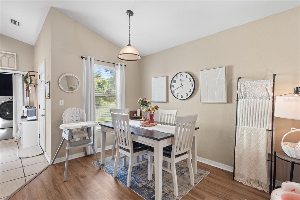 A kitchen features light wood cabinets, laminate countertops, stainless steel appliances, and tile flooring — 308 SW 2ND AVENUE, CHIEFLAND, FL
