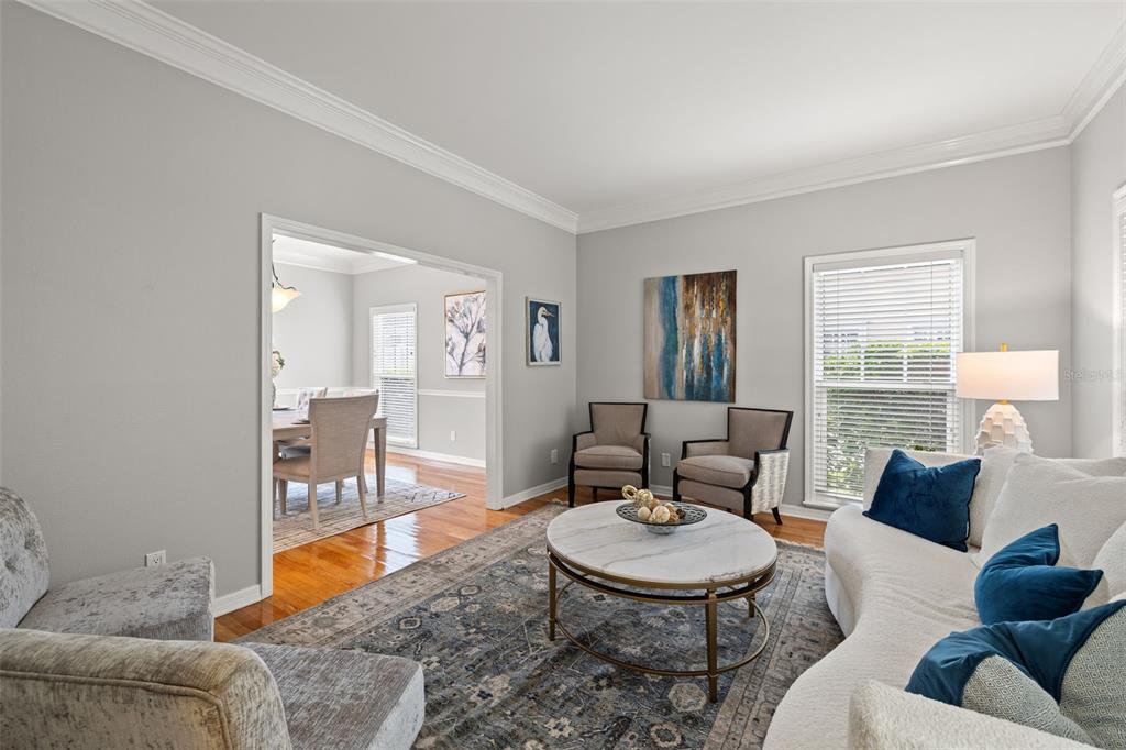 A living room features a curved white sofa, a marble coffee table, and two armchairs — 3233 W PARKLAND BOULEVARD, TAMPA, FL