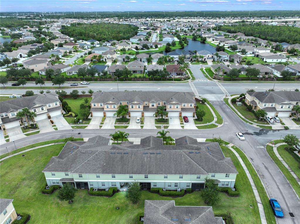 An aerial view shows several rows of suburban townhouses with attached garages and green lawns — 3349 RODRICK CIRCLE, ORLANDO, FL